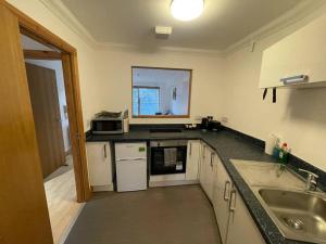 a kitchen with a sink and a counter top at Lovely studio Apartment with balcony in Norwich