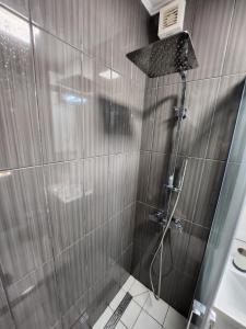 a shower with a glass door in a bathroom at Lovely holiday home in Cres