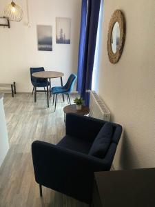 a living room with a couch and a table at Apartments Osterstraße in Norden