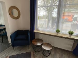a room with two tables and a chair and a window at Apartments Osterstraße in Norden