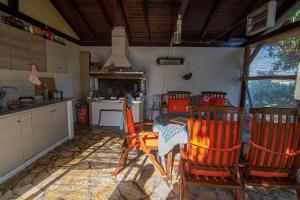 a kitchen with a table and chairs and a stove at The Country House in Preveza