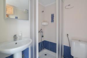 a bathroom with a sink and a shower at Cosy Fourka Beachfront apartment in Skála Foúrkas