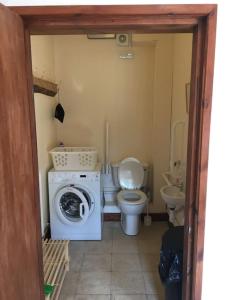 uma casa de banho com uma máquina de lavar roupa e um WC em The Old Stables, Near Bakewell em Millers Dale