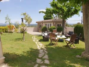 a patio with a table and chairs in a yard at Catalunya Casas Close to Salou and just steps from the village! in Alcover