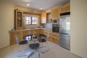 a kitchen with a table and chairs in it at Catalunya Casas Close to Salou and just steps from the village! in Alcover