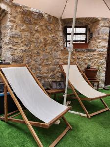 two hammocks in a room with a stone wall at Lovely holiday home in Cres