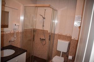 a bathroom with a shower and a toilet and a sink at Golden Rose Residence in Constanţa +42 photos