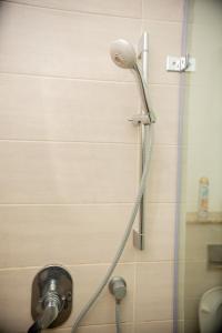 a shower with a shower head in a bathroom at Pura Vida Stays - Nova Apartments in Nairobi +45 photos