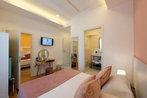 a bedroom with a large bed and a bathroom at Le Angioine Rooms in Naples +96 photos