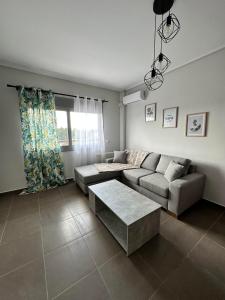 a living room with a couch and a table at EVa's Luxury Apartments No 3 in Áyios Spirídhon