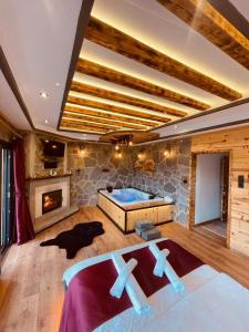 a large room with a bed and a fireplace at MİNTONA VİLLA SUİT in Çamlıhemşin