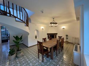 a dining room with a wooden table and chairs at Villa Maera Ravello in Ravello