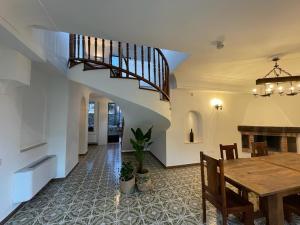 a dining room with a table and a staircase at Villa Maera Ravello in Ravello +18 photos