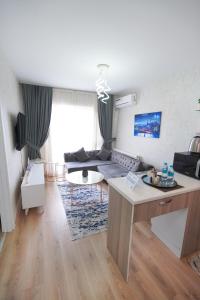 a living room with a couch and a table at Classic Suite BH13 in Esenyurt