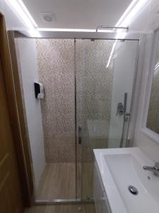 a bathroom with a glass shower and a sink at Casa Rústica da Lavandeira in Valongo dos Azeites