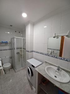 y baño con lavabo, aseo y ducha. en Apartamentos Las Canteras Arena, en Las Palmas de Gran Canaria