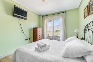 a bedroom with a bed with two towels on it at La Gimena in Orihuela