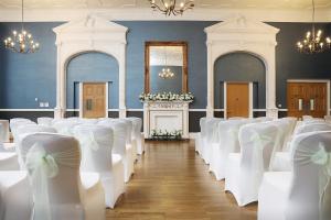 a row of chairs in a room with white bows at Mercure Darlington King's Hotel in Darlington