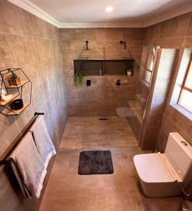 a bathroom with a shower and a toilet and a sink at Zoete Inval - 3 Bedroom Self Catering Home. in Langebaan