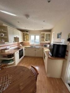 a large kitchen with a table and a dining room at Portmadog, Oakley Wharf in Porthmadog