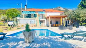 a house with a swimming pool in front of a house at Zion Jardim Monsanto in Monsanto