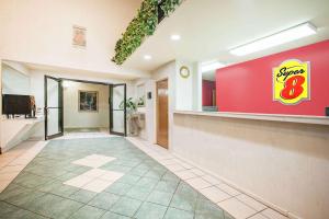 a lobby with a smiley sign on the wall at Super 8 by Wyndham White Hall in White Hall