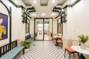 a corridor of a restaurant with tables and chairs at Sun Clover Boutique Hotel in Hanoi +99 photos