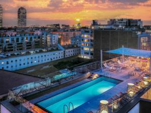 a swimming pool on the roof of a building at ibis Styles Barcelona City Bogatell in Barcelona