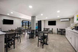 un comedor con mesas, sillas y TV en Quality Inn Gadsden - Attalla, en Gadsden