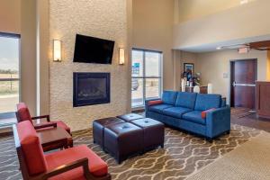 a living room with a couch and a fireplace at Comfort Inn & Suites in Edgewood