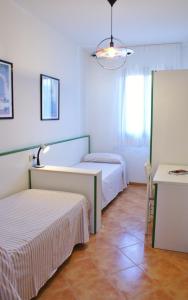 Postel nebo postele na pokoji v ubytování Appartamento Al Porticciolo-Residence con piscina-Cavallino Treporti + 7 fotografií