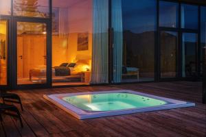 a hot tub on the deck of a house at Apartmány PANORAMA Bachledka in Ždiar
