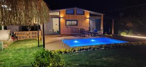 a small swimming pool in a backyard at night at Arkaya TinyHouse in Fethiye