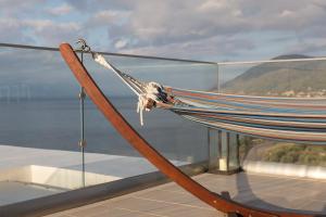 a hammock on top of a building with a view of the ocean at Super Luxurious Villa - 600m² - Up to 22 people in Edipsos