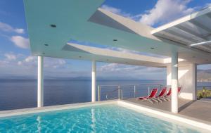 a swimming pool on the deck of a house at Super Luxurious Villa - 600m² - Up to 22 people in Edipsos