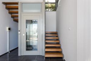 a staircase leading up to a door in a house at Super Luxurious Villa - 600m² - Up to 22 people in Edipsos