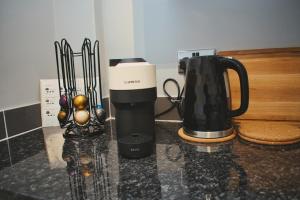 a coffeemaker and a coffee maker on a counter at Cosy 2 Bedroom Flat in Sunderland in Sunderland