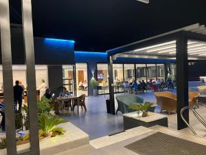 a group of people sitting at tables in a building at mass paradise2 in Aqaba