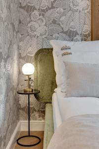 a bedroom with a bed and a side table with a lamp at Downtown Apartments The Love Bridge - Na Piaskach in Gdańsk