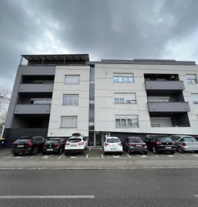 a parking lot with cars parked in front of a building at Luxury apartment Anabella in Varaždin