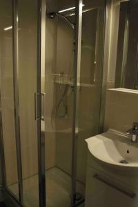 a bathroom with a shower and a sink at Babalù Con vista lago in Arona +29 photos