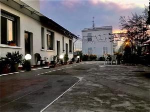an empty street next to a white building at Parco Teramo - Navigli CIR 15146-LNI 299 in Milan