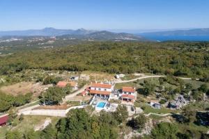 an aerial view of a house on a hill at Villa LULU with heated pool, sauna & hot tub in Labin