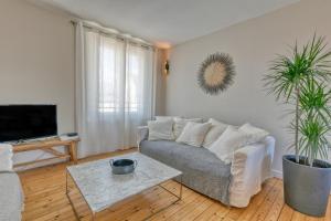 a living room with a couch and a table at Superbe appartement bord de mer in Pornichet