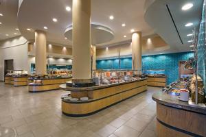 a restaurant with wooden counters and blue tiles at Xanadu Island in Akyarlar