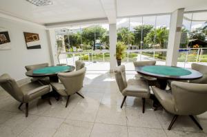 a dining room with two tables and chairs at Império Romano - Splash e Acqua Park in Caldas Novas