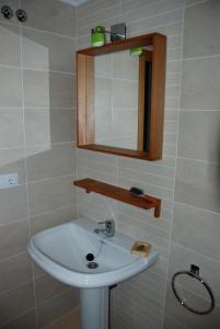 y baño con lavabo blanco y espejo. en APARTAMENTO ESPASANTE, en Porto de Espasante