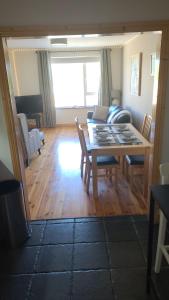 a living room with a wooden table and chairs at Broadhaven Bay Apartment in Belmullet