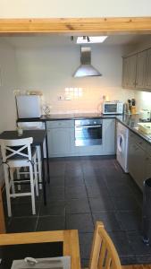a kitchen with a table and a stove top oven at Broadhaven Bay Apartment in Belmullet