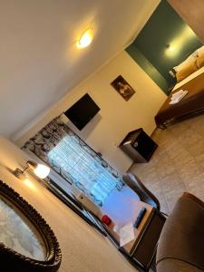 A bed or beds in a room at Queen of Orliaka